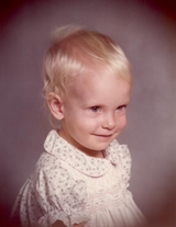 Studio image of smiling toddler with soft background