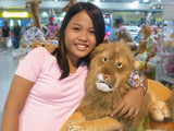 Young teen at the mall with her arm around a stuffed lion