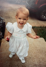 Toddler standing on steps outside