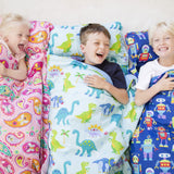 3 Children laughing together while laying in nap mats with Paisley, Dinosaur Land, and Robots designs.