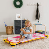 Girl sitting on Ballerina modern nap mat attached to a cot