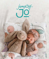 JumpOff Jo Logo on images with a baby sleeping with stuffed rabbit in Fairy Blossom Nap Mat. 