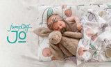 JumpOff Jo Logo on images with a baby sleeping with stuffed rabbit in Fairy Blossom Nap Mat. 