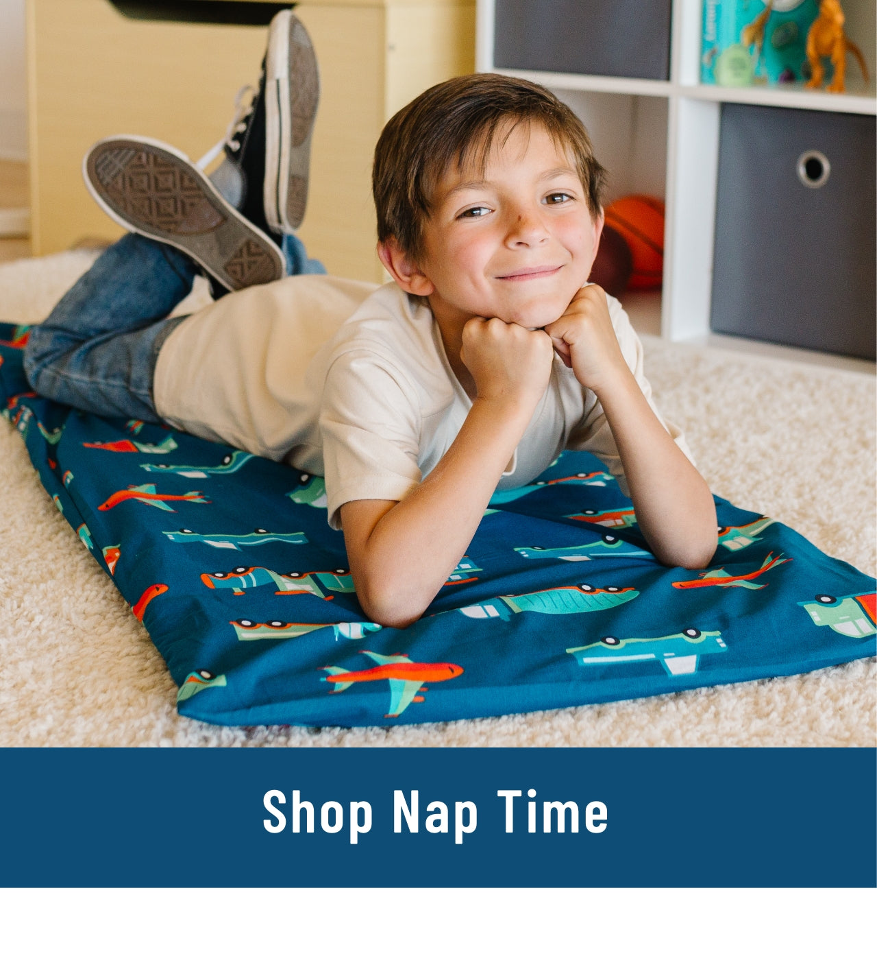 Link to Shop Nap Mats. Image of boy laying on a rest mat with a transportation rest mat cover.
