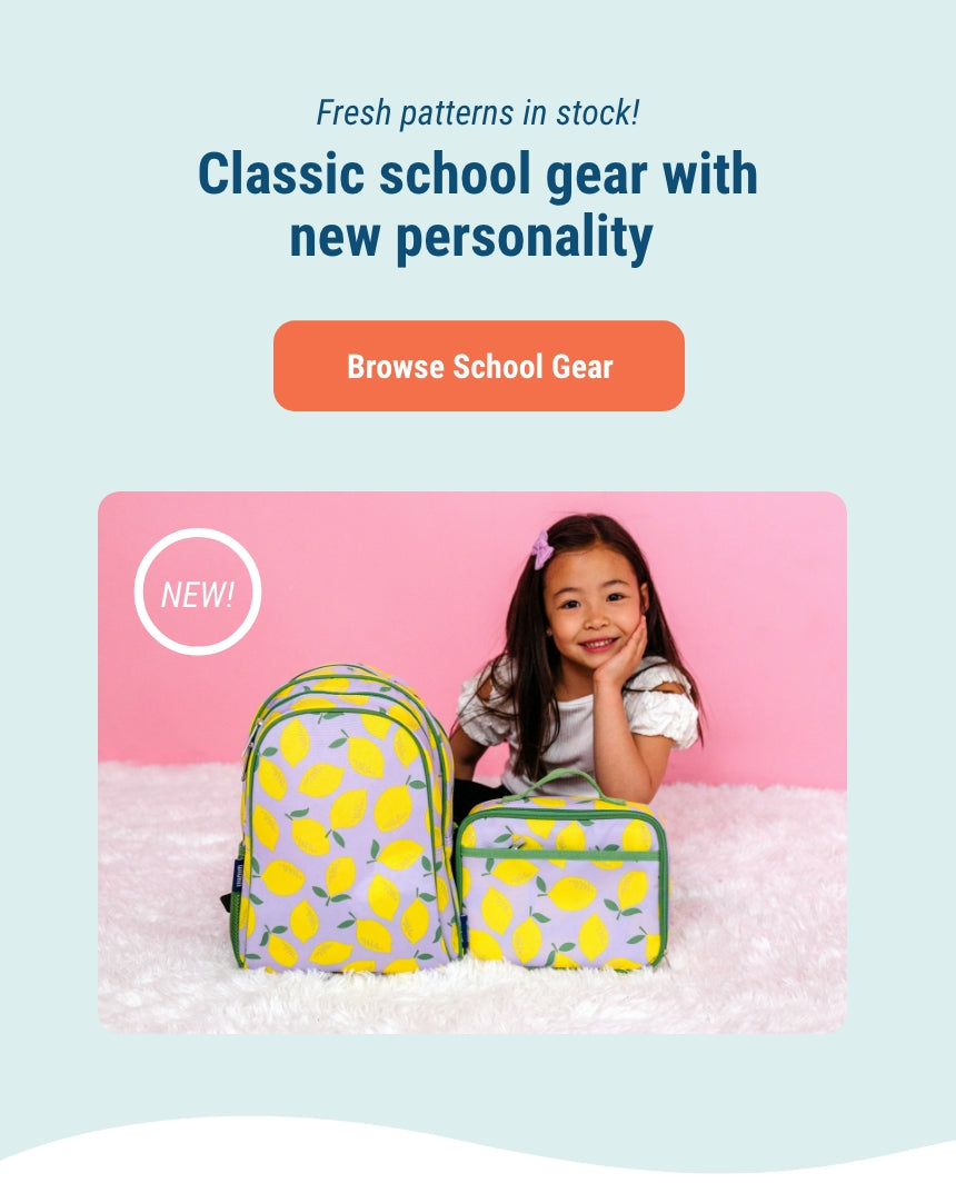 Fresh patterns now in stock! Classic school gear with new personality. Link to Browse school gear. Image of girl sitting on floor with lilac lemonade Lunch box and backpack