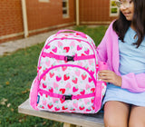 Girl sitting outside school with Strawberry Patch Next Gen Eco Backpack and strawberry patch 18oz water bottle