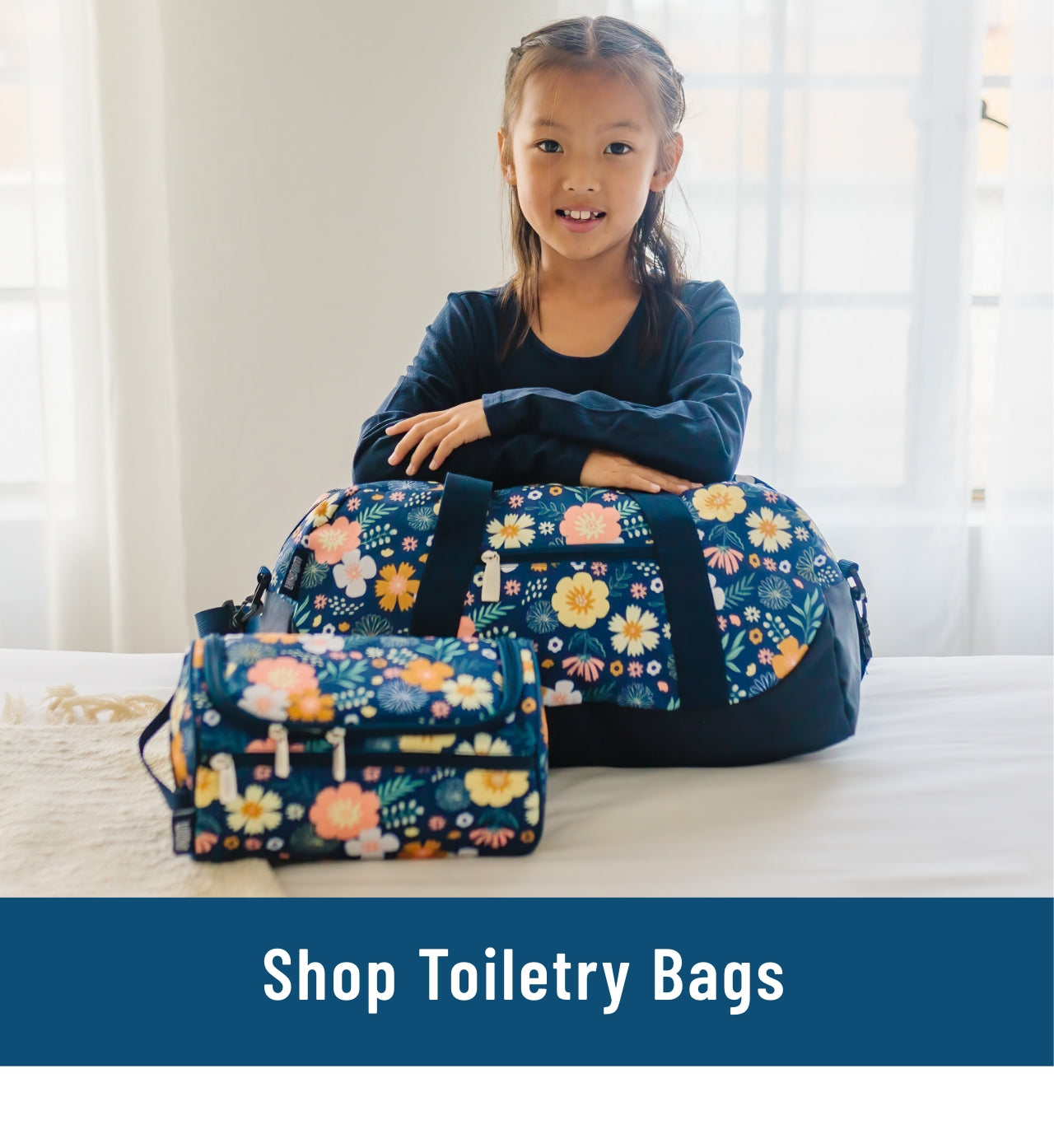 Image of girl smiling with matching duffel bag and toiletry bag with the Wildflower Bloom pattern. Link to shop toiletry bags.