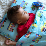 Boy laying on nap mat with blanket over him